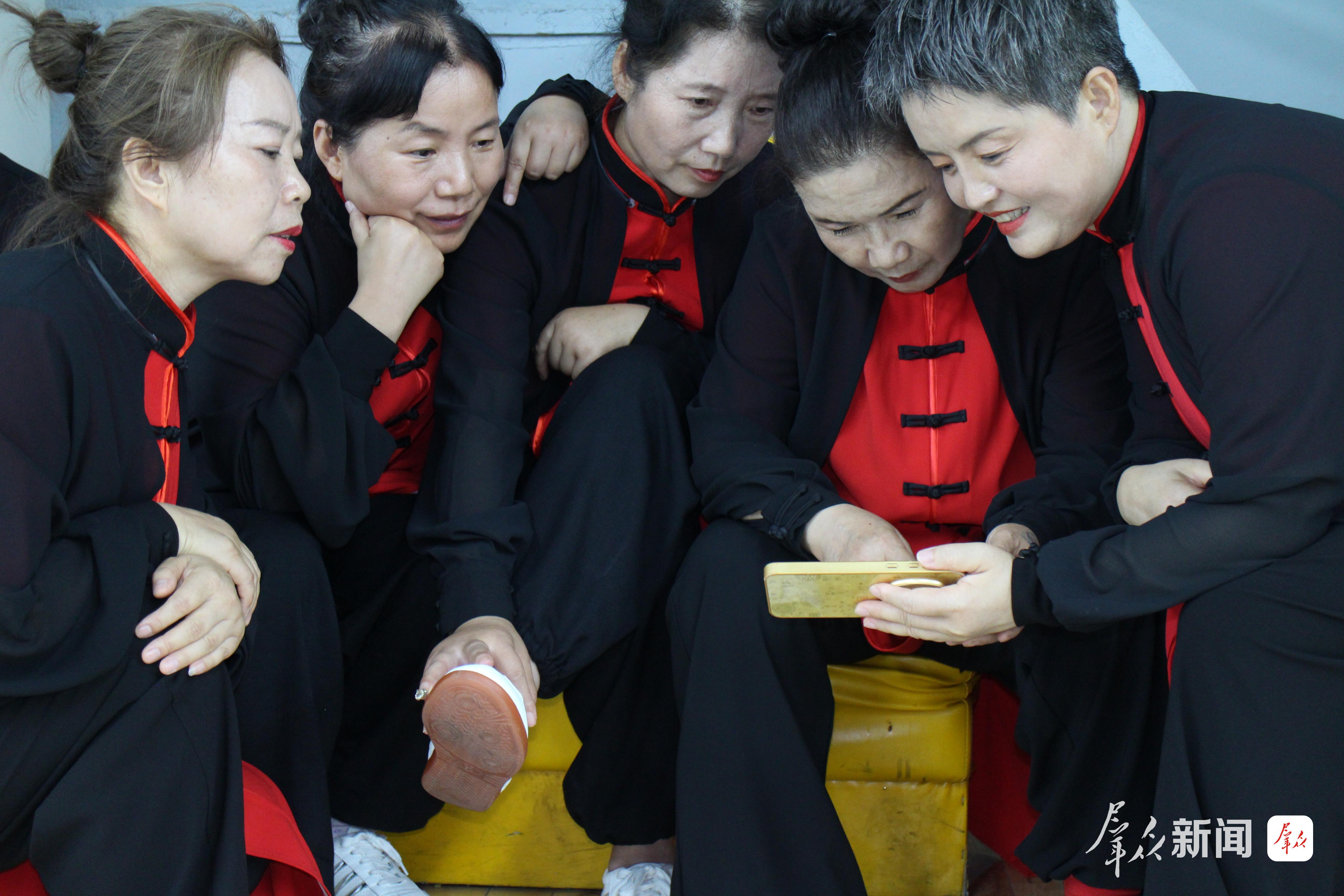 9月5日,来自咸阳市各区县的太极拳运动爱好者,正在“全民健身 运动三秦”2026年陕西省群众体育五级联赛暨社区运动会(咸阳赛区)太极拳比赛结束后,高兴地欣赏比赛时的视频。