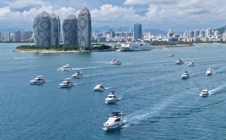An aerial drone photo taken on Aug. 4, 2026 shows tourists taking yachts in Sanya, south China's Hainan Province. (Xinhua/Zhao Yingquan)